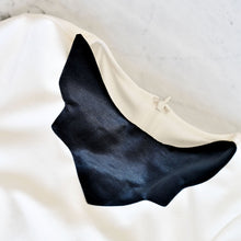 Load image into Gallery viewer, Sweaterly Classic: The Sweaterly protects your garment neckline from cosmetic stains in just three simple snaps! This patent-pending design sticks to your neckline without causing pilling, pulling, poking or stretching. Sweaterly is safe on all fabric types and strong enough for most fabric weights. It works on blouses, sweaters, turtlenecks, dresses and even v-necks.