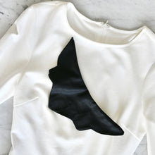 Load image into Gallery viewer, Sweaterly Classic: The Sweaterly protects your garment neckline from cosmetic stains in just three simple snaps! This patent-pending design sticks to your neckline without causing pilling, pulling, poking or stretching. Sweaterly is safe on all fabric types and strong enough for most fabric weights. It works on blouses, sweaters, turtlenecks, dresses and even v-necks.