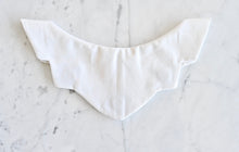 Load image into Gallery viewer, Sweaterly White Shimmer: The Sweaterly protects your garment neckline from cosmetic stains in just three simple snaps! This patent-pending design sticks to your neckline without causing pilling, pulling, poking or stretching. Sweaterly is safe on all fabric types and strong enough for most fabric weights. It works on blouses, sweaters, turtlenecks, dresses and even v-necks.
