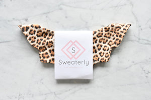 Sweaterly Leopard (Gold): The Sweaterly protects your garment neckline from cosmetic stains in just three simple snaps! This patent-pending design sticks to your neckline without causing pilling, pulling, poking or stretching. Sweaterly is safe on all fabric types and strong enough for most fabric weights. It works on blouses, sweaters, turtlenecks, dresses and even v-necks.