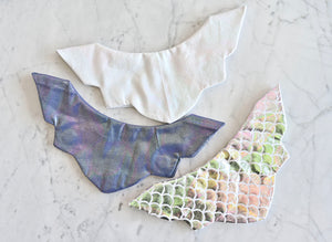 Sweaterly Mermaid: The Sweaterly protects your garment neckline from cosmetic stains in just three simple snaps! This patent-pending design sticks to your neckline without causing pilling, pulling, poking or stretching. Sweaterly is safe on all fabric types and strong enough for most fabric weights. It works on blouses, sweaters, turtlenecks, dresses and even v-necks.